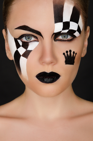 face of woman with black and white pattern on black backgroundの写真素材
