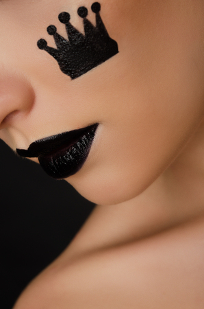 face of beautiful woman with black pattern crownの写真素材