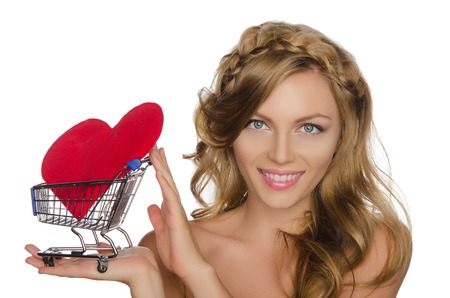 young woman with heart in shopping cart isolated on whiteの写真素材