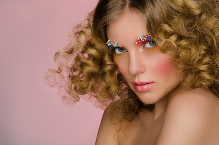 portrait of beautiful woman on pink backgroundの写真素材