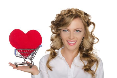 European woman with heart in shopping cart isolated on whiteの写真素材