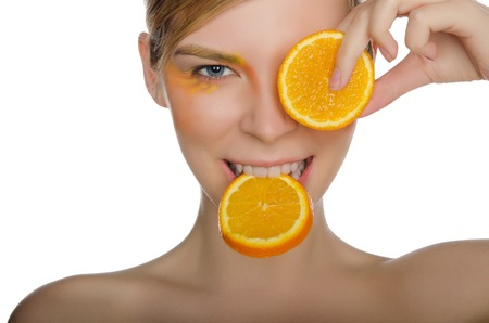 beautiful woman with orange isolated on whiteの写真素材