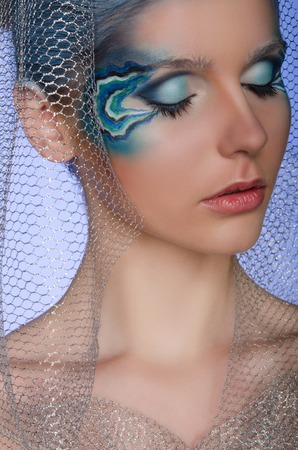 woman with face art mermaid with blue backgroundの写真素材