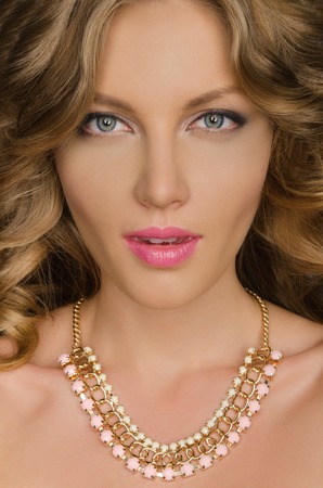 portrait of beautiful woman with necklace on neckの写真素材