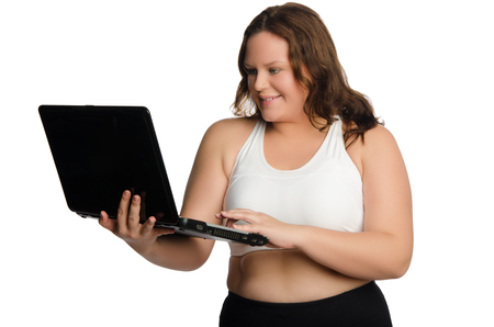 Fat sporty woman with laptop isolated on whiteの写真素材