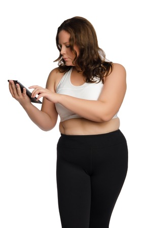 Fat athletic woman with tablet isolated on whiteの写真素材