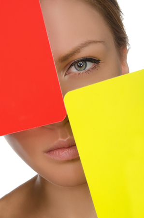 European young woman with red and yellow card isolated on whiteの写真素材
