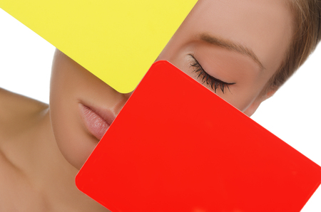 portrait of woman with red and yellow card isolated on whiteの写真素材