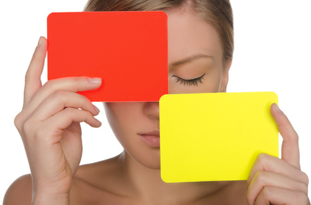 beautiful woman with red and yellow card isolated on whiteの写真素材