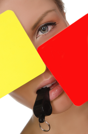 woman, red and yellow soccer referee and whistle isolated on whiteの写真素材
