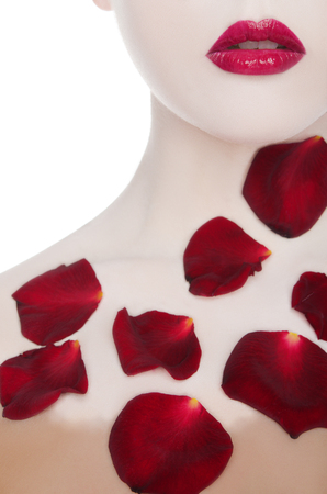 white woman with red lips and rose petals isolated on whiteの写真素材