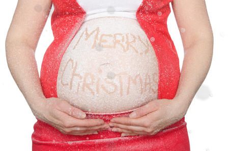 Belly of a pregnant woman with a Christmas greeting isolated on whiteの写真素材