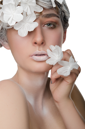 portrait of a young woman with a snow make-up isolated on whiteの写真素材