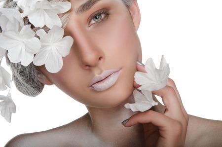 charming woman with a winter make-up isolated on whiteの写真素材