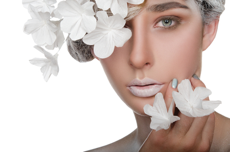 Portrait of a beautiful woman with a snow make-up isolated on whiteの写真素材