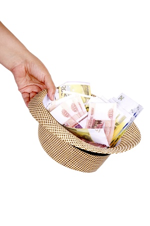 woman s hand holding a hat with banknotes in denominations of five thousand rubles and two hundred euro  on a white backgroundの写真素材