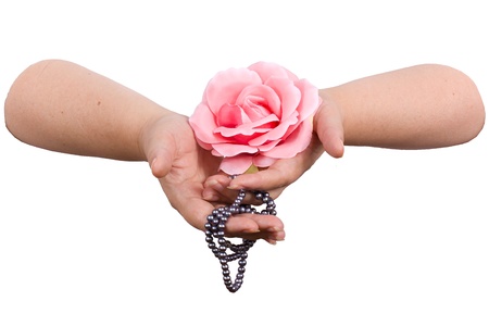 silk pink rose and string of black pearls in the women s hands on a white background の写真素材
