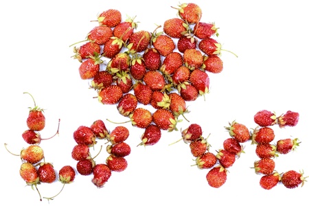 the heart and the word LOVE made ââup of ripe red strawberries on a white backgroundの写真素材