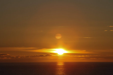 Sunset over seas with cloudsの写真素材