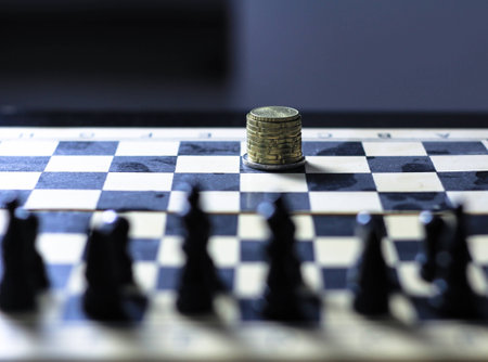 Picture of a chess board with stack of coins as the kingの写真素材