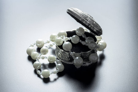 Picture of a silver jewellery box with white pearls shot with studio lights and black backgroundの写真素材