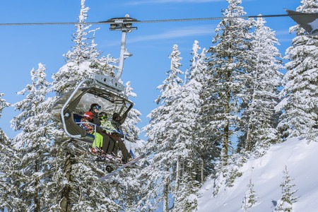 POIANA BRASOV, ROMANIA - JANUARY 24, 2016: Tourists in chairlift in winter season going to the ski slope in resort Poiana Brasov, Romaniaのeditorial素材