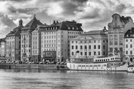 STOCKHOLM, SWEDEN - MARCH 30, 2016: Old buildings on the shore of the Stockholm harbor from Sweden in black and whiteのeditorial素材