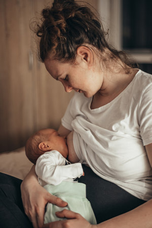 Cropped shot of a mother breastfeeding her newborn son at homeの写真素材