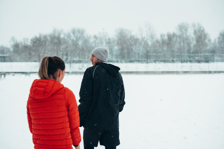 Shot of an attractive young couple working out outside on a winter day during snowの写真素材