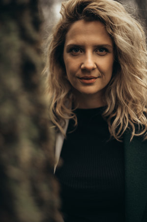 Portrait of a beautiful young blonde woman while walking in the natureの写真素材