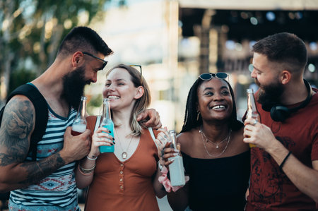Group of friends drinking cocktails and having fun at music festivalの写真素材