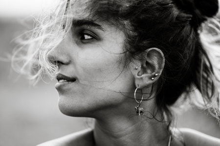 Black and white portrait photo of a beautiful girl posing outsideの写真素材