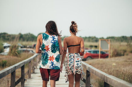 Attractive young couple walking on the beachの写真素材