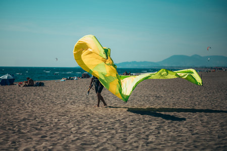 Man in a wetsuit with a helmet preparing kiteboarding kite before kitesurfing. Preparation before kiting.の写真素材
