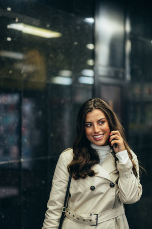 Beautiful young woman using a smartphone while in the subway waiting for her transportation