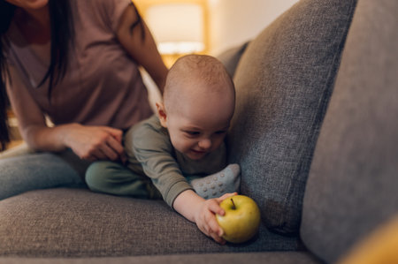 Adorable small baby boy and his mother enjoying moments of love and affection and learning to eat...