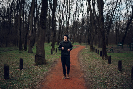 Redhead male jogging and training for marathon on a forest road in amazing nature. Sport active...