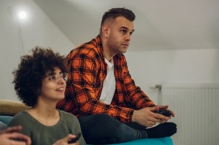 Multiracial group of friends playing video games at home and having fun. Young people having fun...