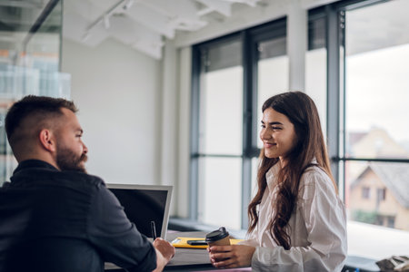 Male and female colleagues discussing online software business strategies and collaborating while...