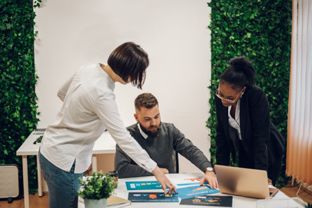 Young multiracial colleagues discussing a start up idea or a new business project. Teamwork, cooperation, successful business development concept. Business professionals. Teamwork concept.の写真素材