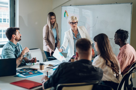 Diverse creative business team working together in the meeting room of a modern company....