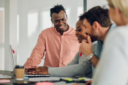Young group of multiracial colleagues talking about company financial paperwork during a meeting in...