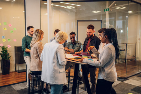 Fun multiracial young creative people in a modern office. Group of diverse business people working together in the creative co-working space. Working with fun people.の写真素材