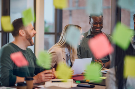 Diverse colleagues gathered in the office having fun during brainstorming while discussing new ideas...