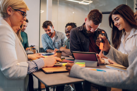 Multicultural project managers group negotiating in boardroom at meeting. Creative diverse team discussing the concept of business strategy in their project. Focus on a bearded man using tablet.の写真素材
