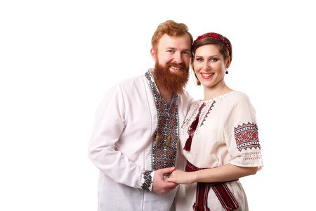 Young couple in Ukrainian style costumes over whiteの写真素材
