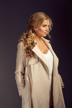 sexy girl with long blond hair in beige fur coatの写真素材
