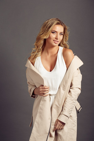 sexy girl with long blond hair in beige fur coatの写真素材