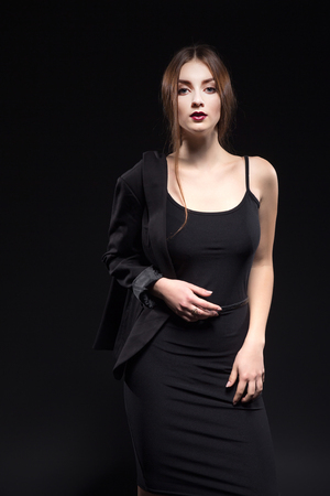 beautiful woman in sexy evening dress against dark backgroundの写真素材