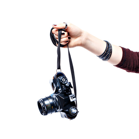 Woman hand holding old camera isolated on white backgroundの写真素材